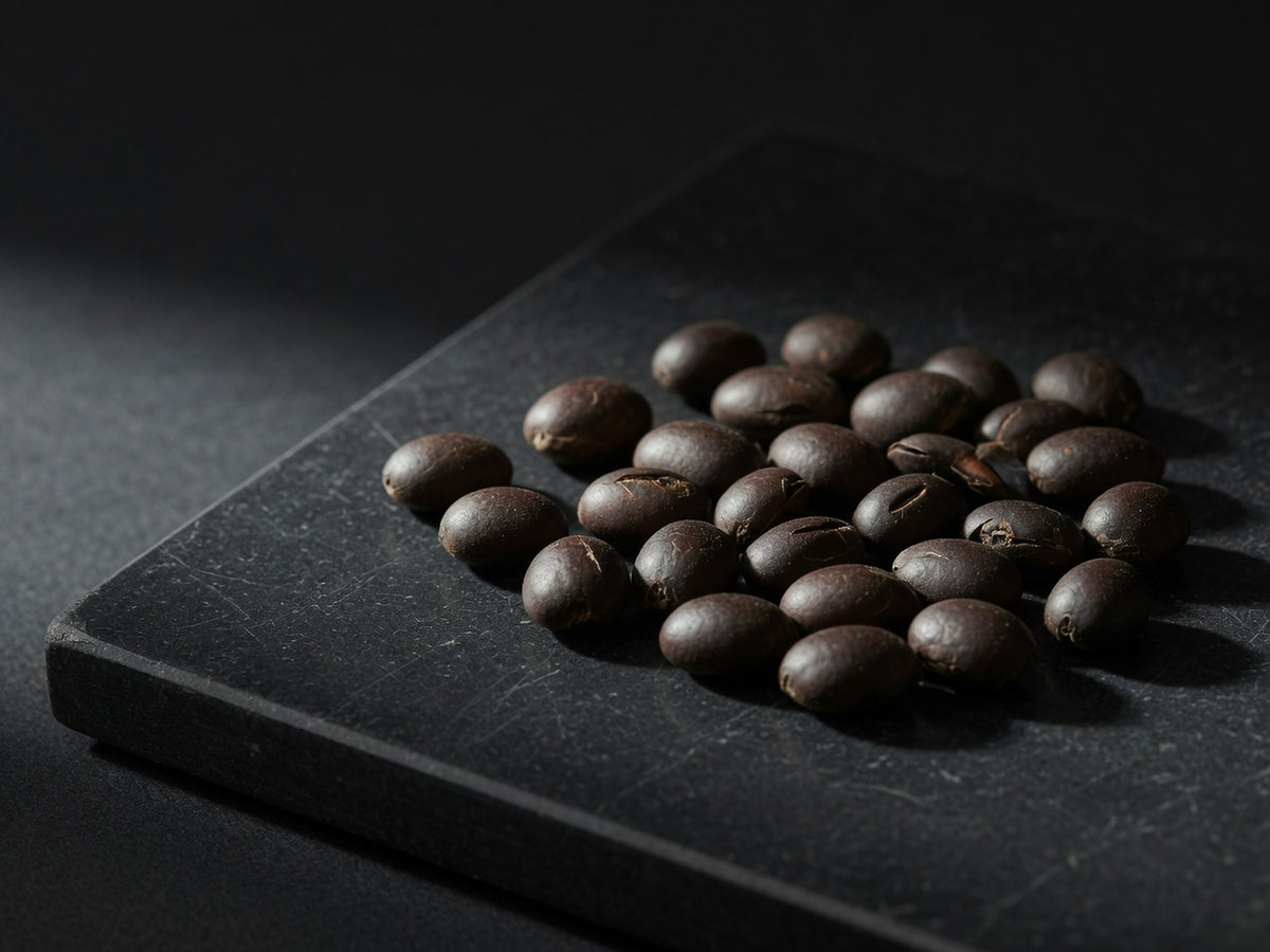 Round dark brown Griffonia seeds, hard like small coffee beans.