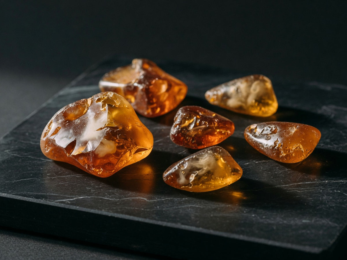 Glossy amber nodules of acacia gum, translucent and irregular.