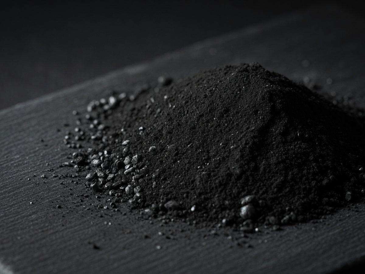 A velvety mound of jet-black ultra-fine activated charcoal powder.