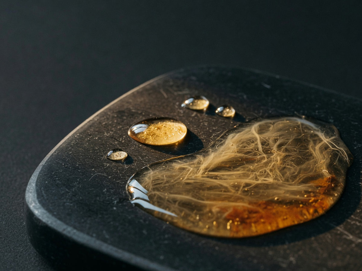 A pool of amber-gold unfiltered cider vinegar with visible mother strands.