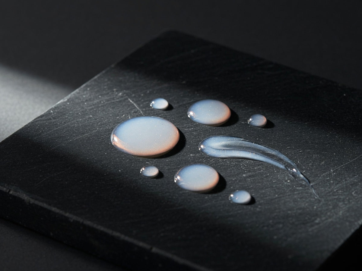 Droplets and a short trail of slightly opalescent clear serum.