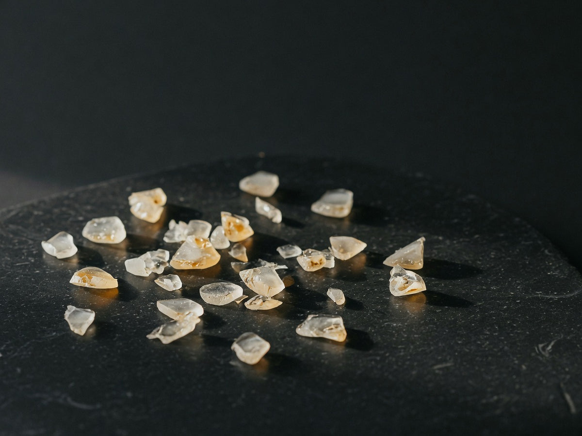 A scatter of small glassy fragments, clear and faintly amber.